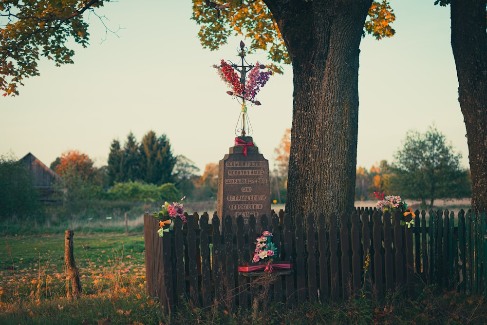 a wooden fence with a statue on top of it