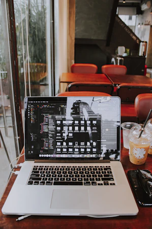 a laptop computer sitting on top of a wooden table