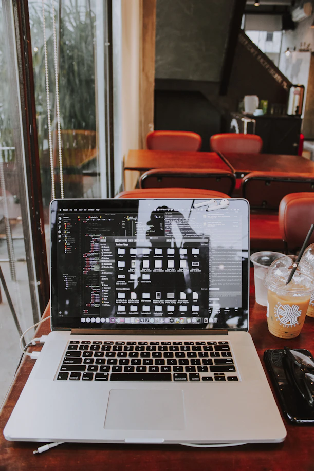 a laptop computer sitting on top of a wooden table