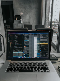 Modern workspace with a laptop displaying construction cost estimates generated by AI.