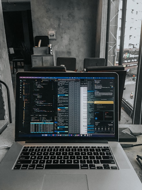 A developer working on a laptop in a bright, open office space.