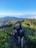 Group of friends hiking a scenic mountain trail under a bright blue sky.