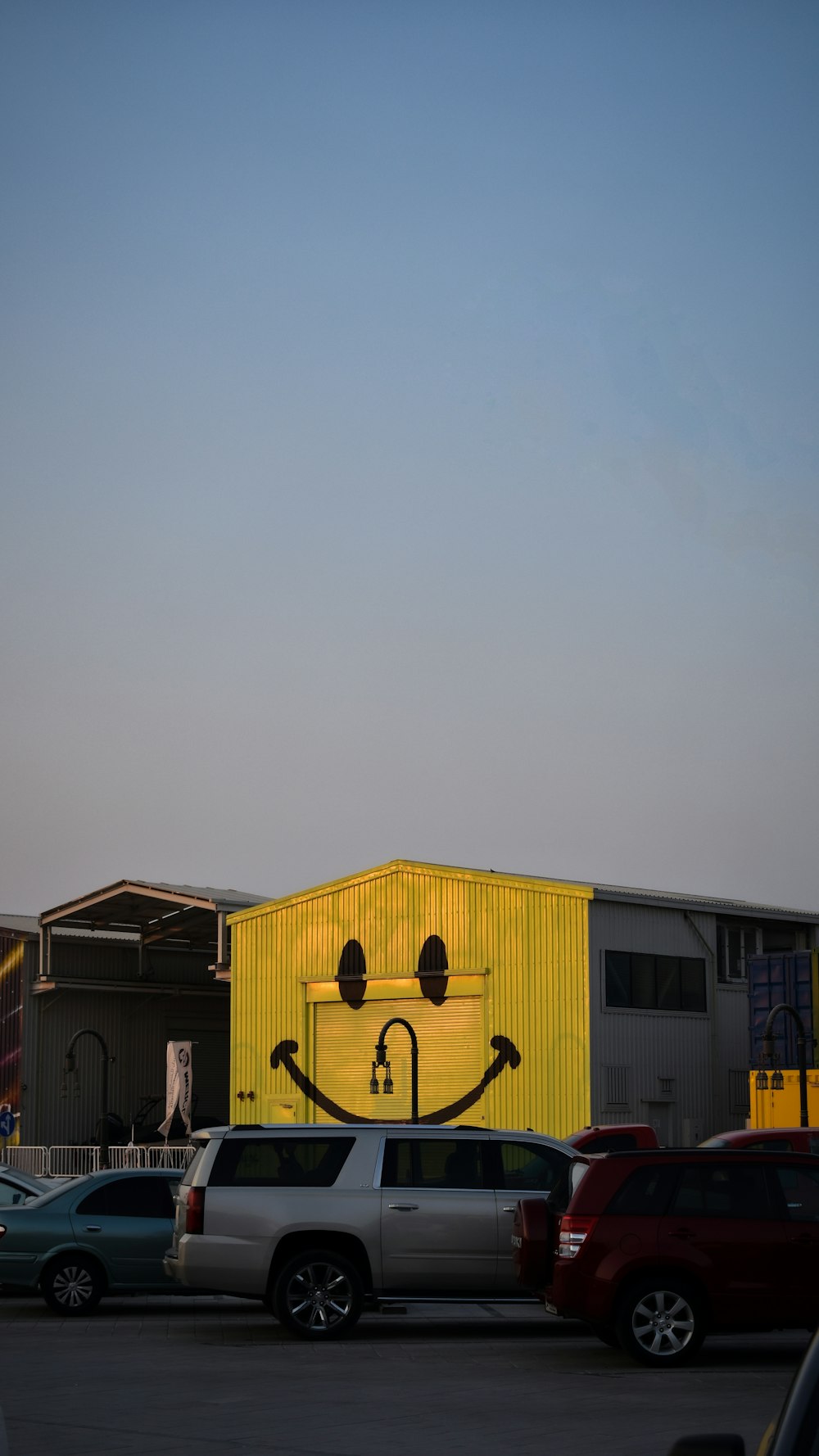 a yellow building with a smiley face painted on it