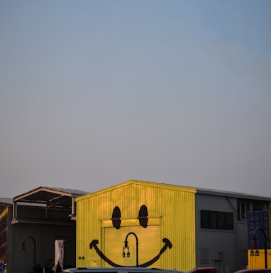 a yellow building with a smiley face painted on it
