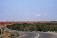 a curved road in the middle of the desert