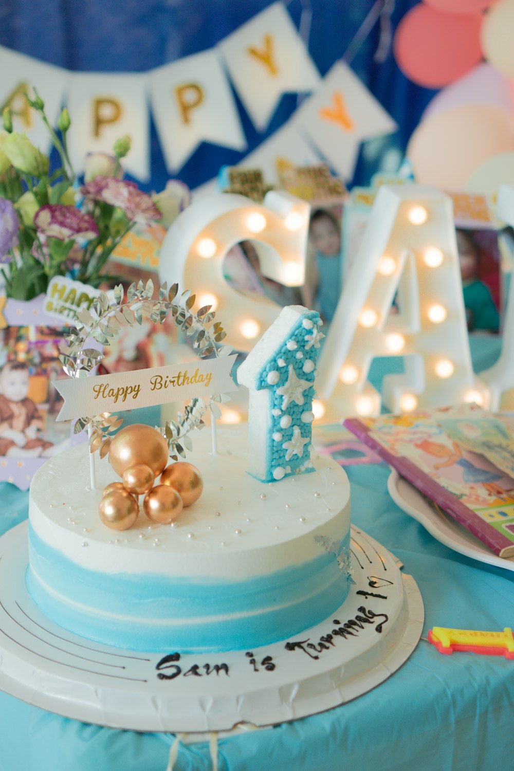 a blue and white cake sitting on top of a table