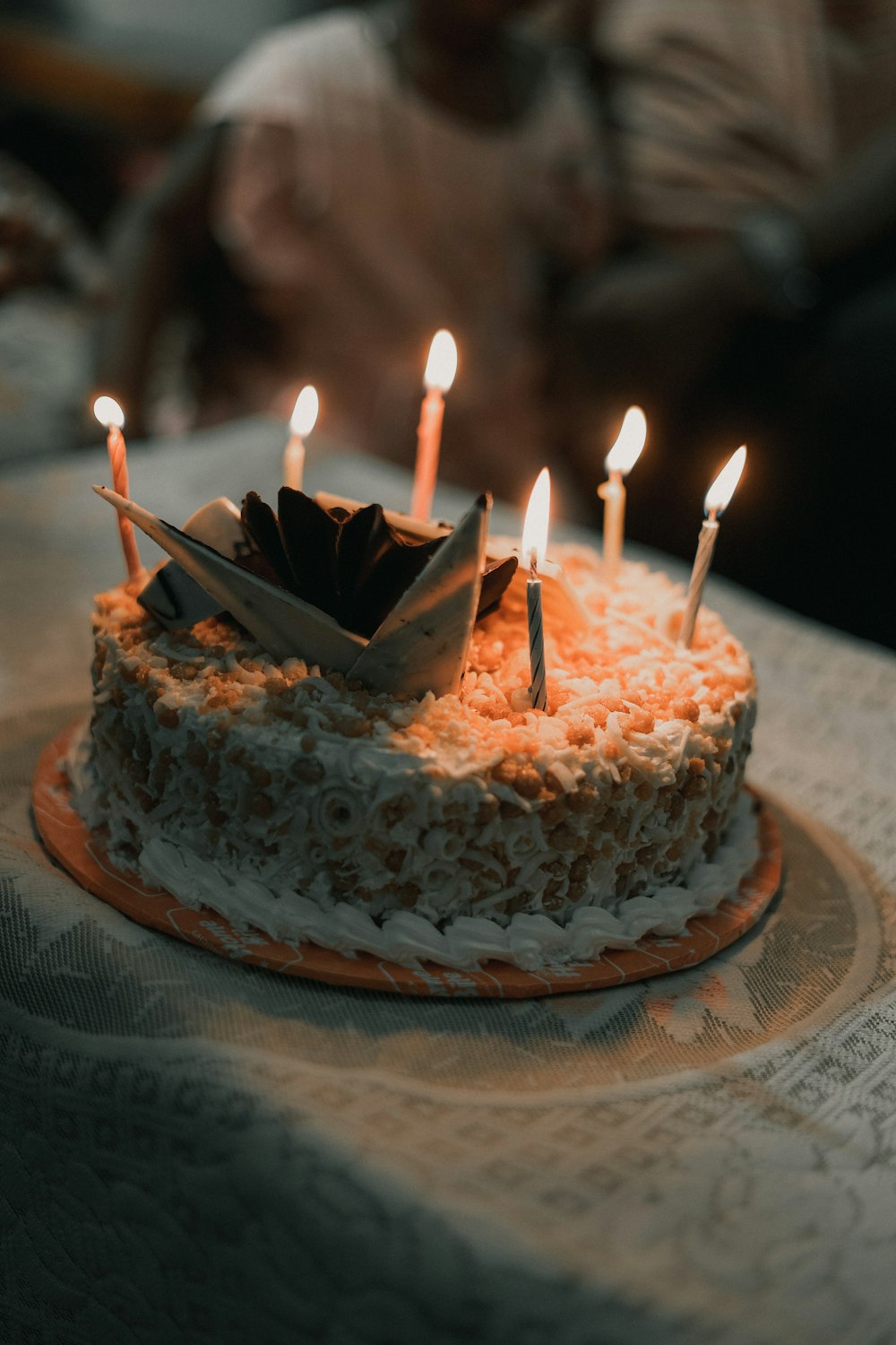 a birthday cake with lit candles on a table