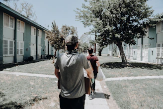 a group of people walking down a sidewalk