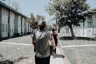a group of people walking down a sidewalk