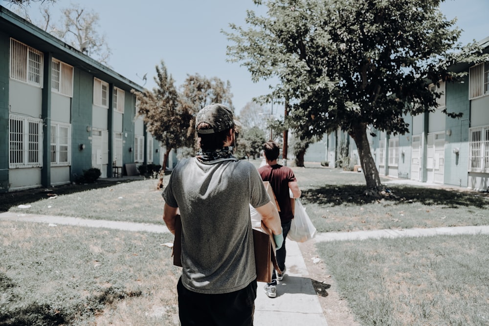 a group of people walking down a sidewalk