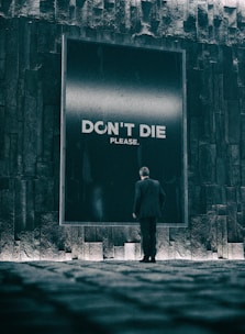 a person standing in front of a brick building