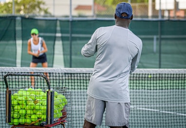 a man and a woman playing tennis on a tennis court