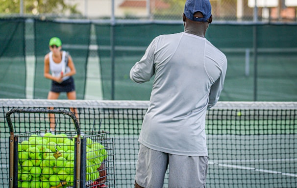 a man and a woman playing tennis on a tennis court