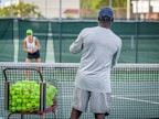 a man and a woman playing tennis on a tennis court