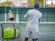 a man and a woman playing tennis on a tennis court