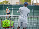 a man and a woman playing tennis on a tennis court