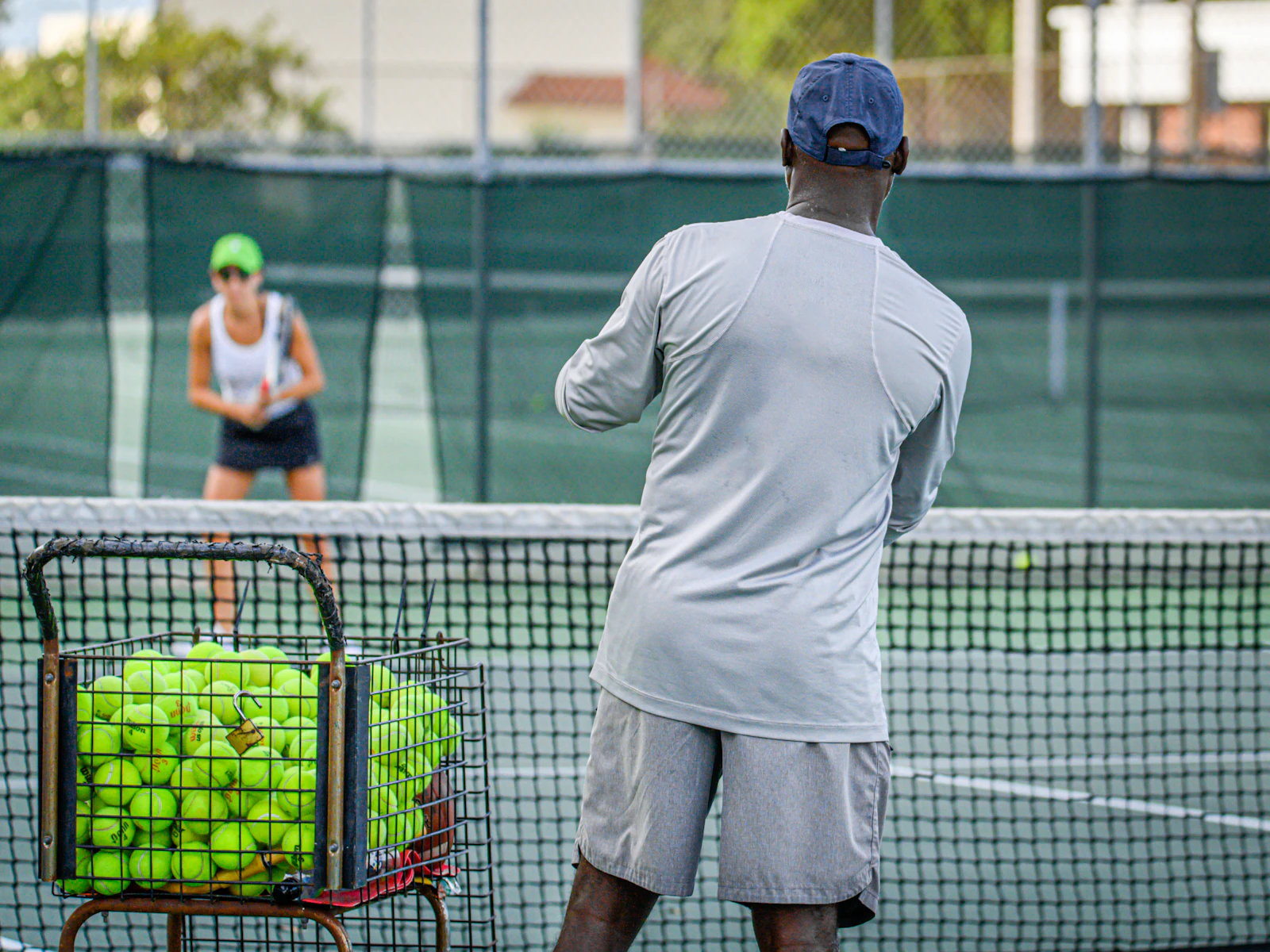 A coach and player together on a court during a one-on-one lesson