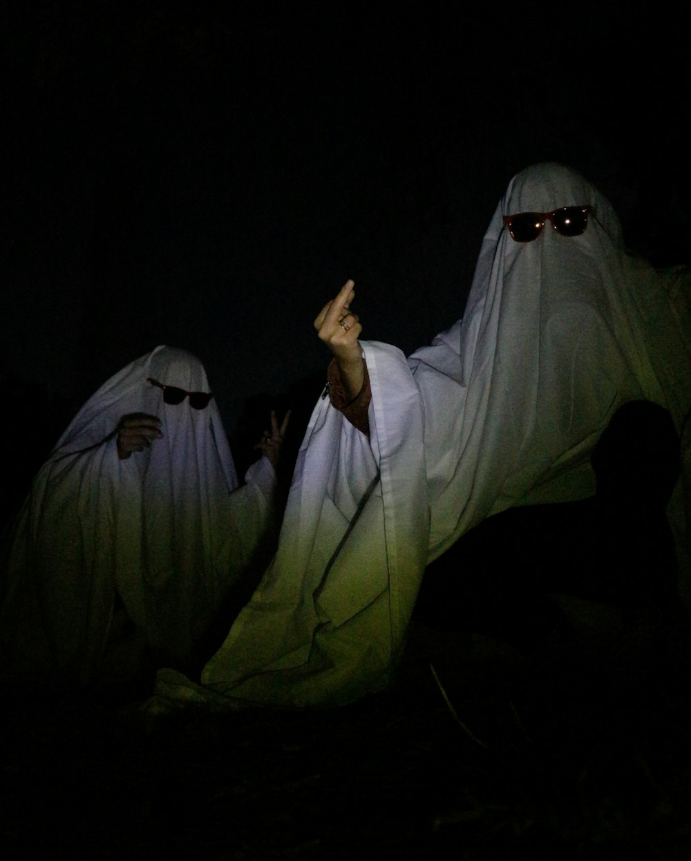 two people dressed in white in the dark