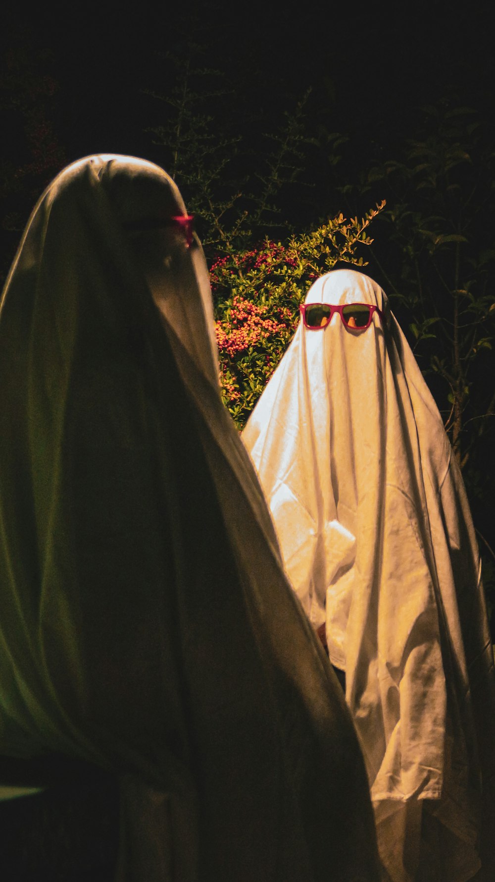 two people dressed in white and wearing sunglasses