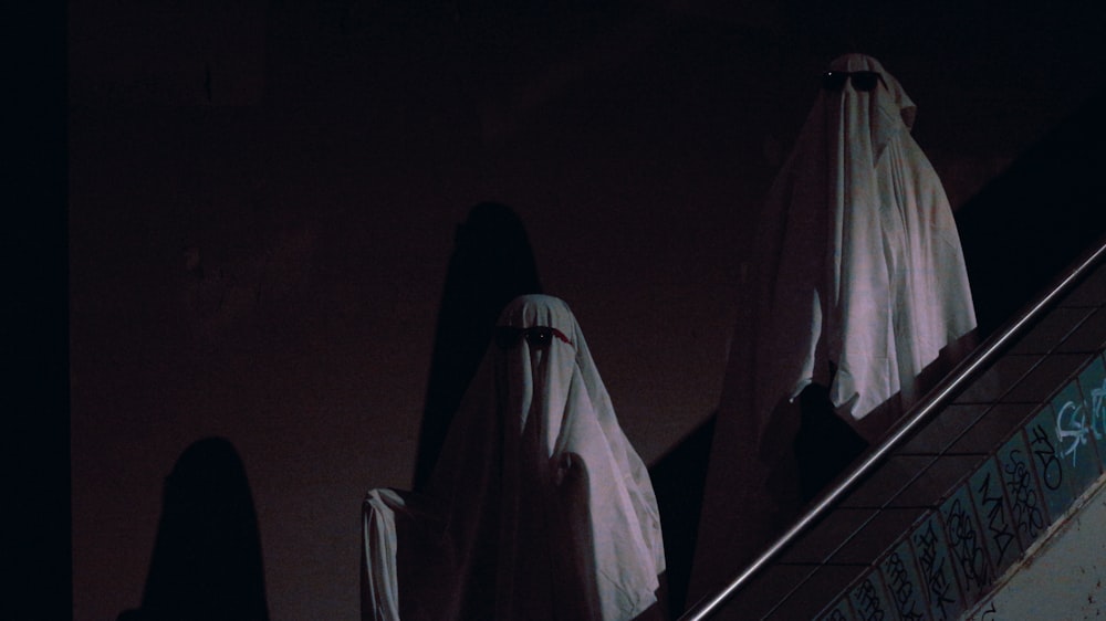 a group of ghostly people walking down an escalator