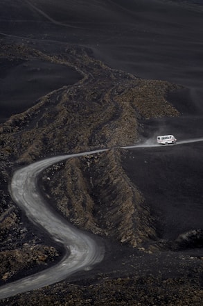 a car driving down a winding road in the mountains