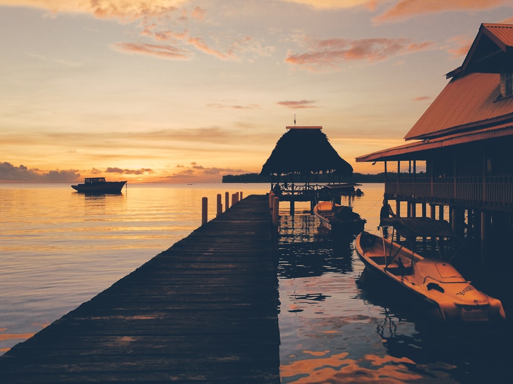 a boat is docked at the end of a pier