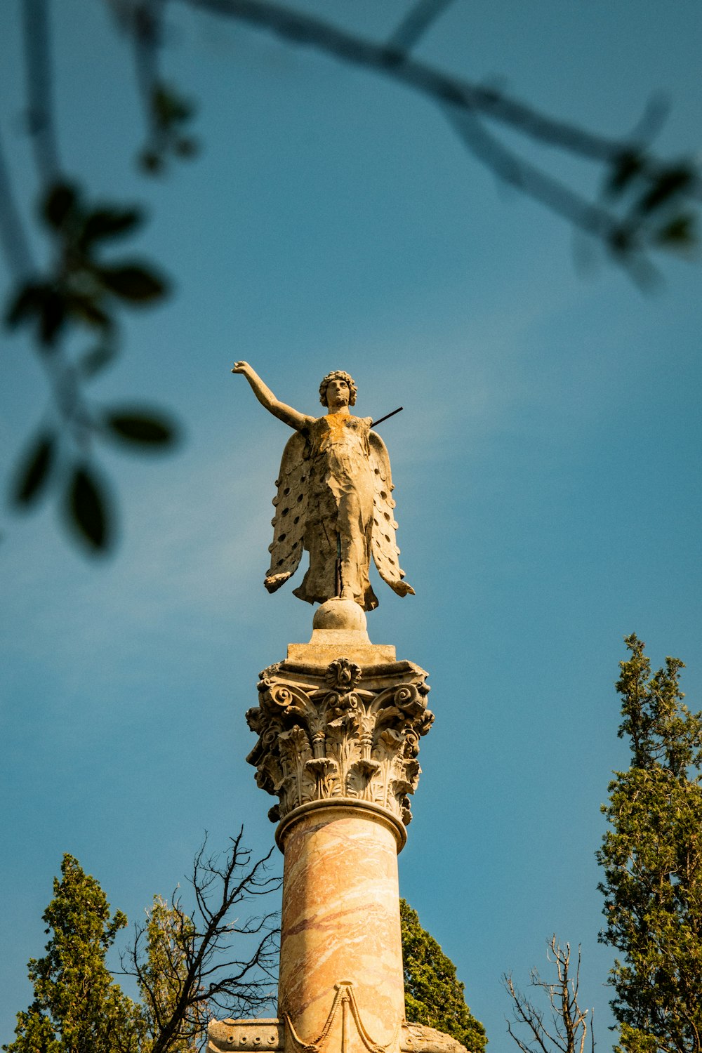 a statue of an angel on top of a building