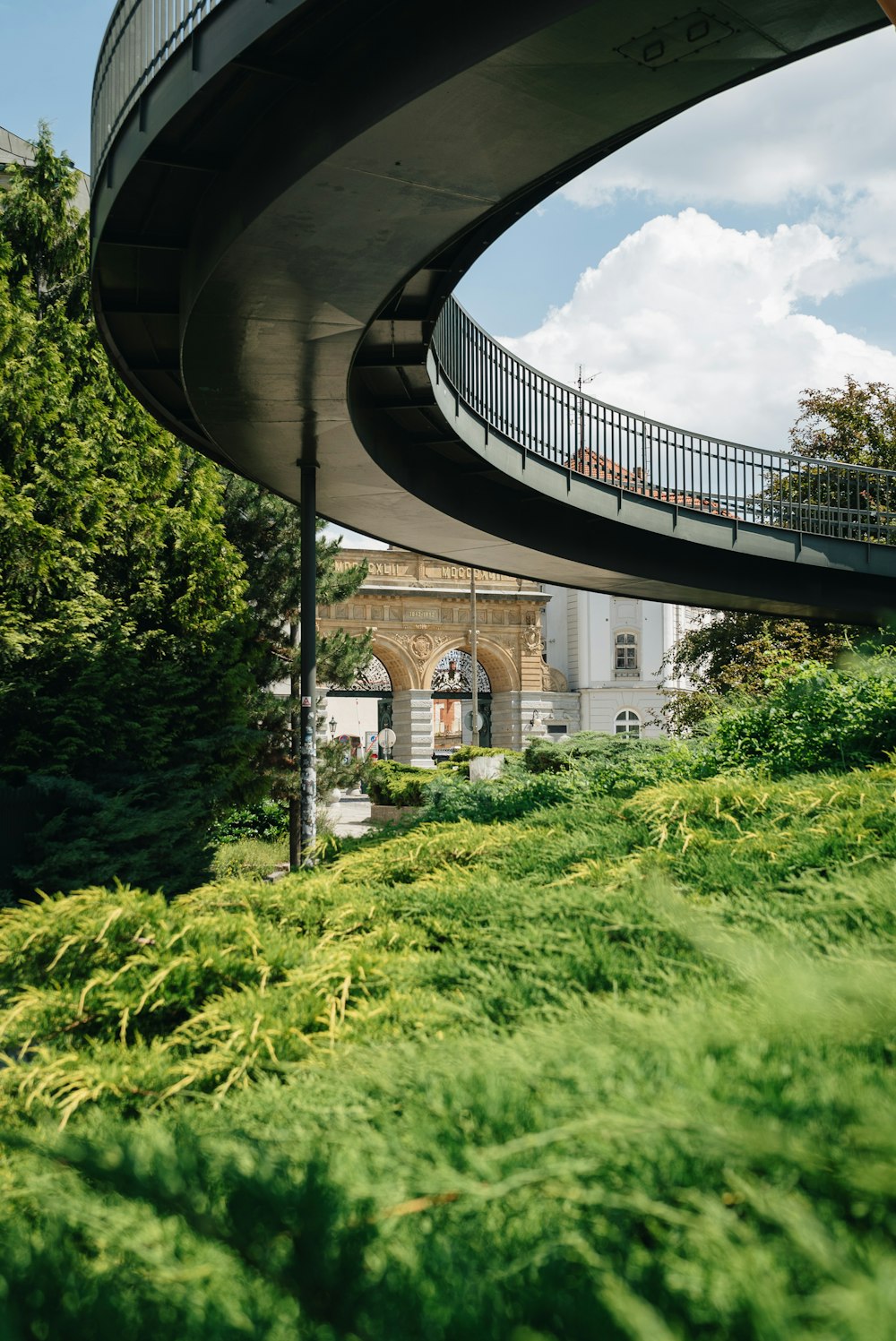 a curved building with a walkway going up the side of it