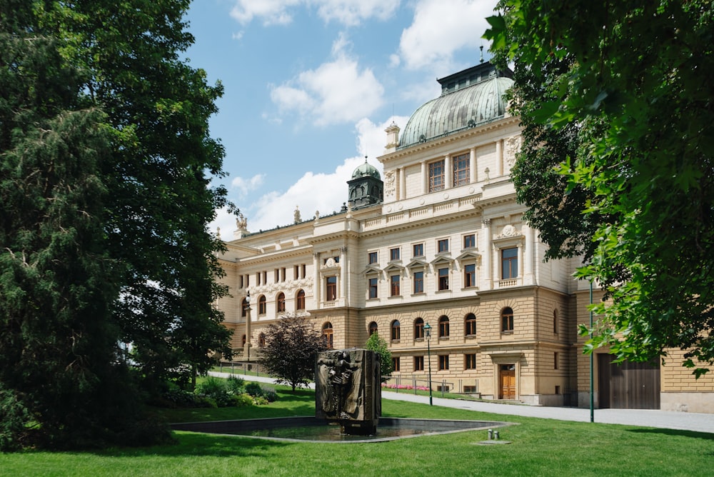 a large building with a fountain in front of it