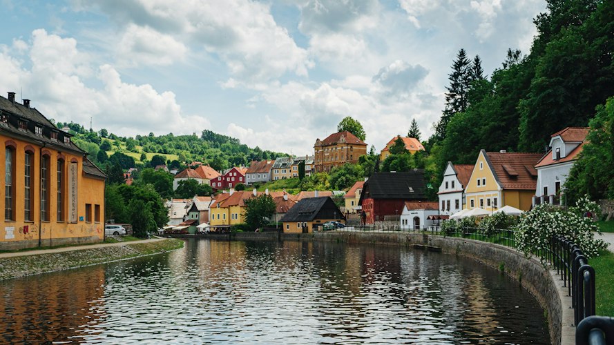 A narrow cobblestone street lined with colorful old buildings in a European town