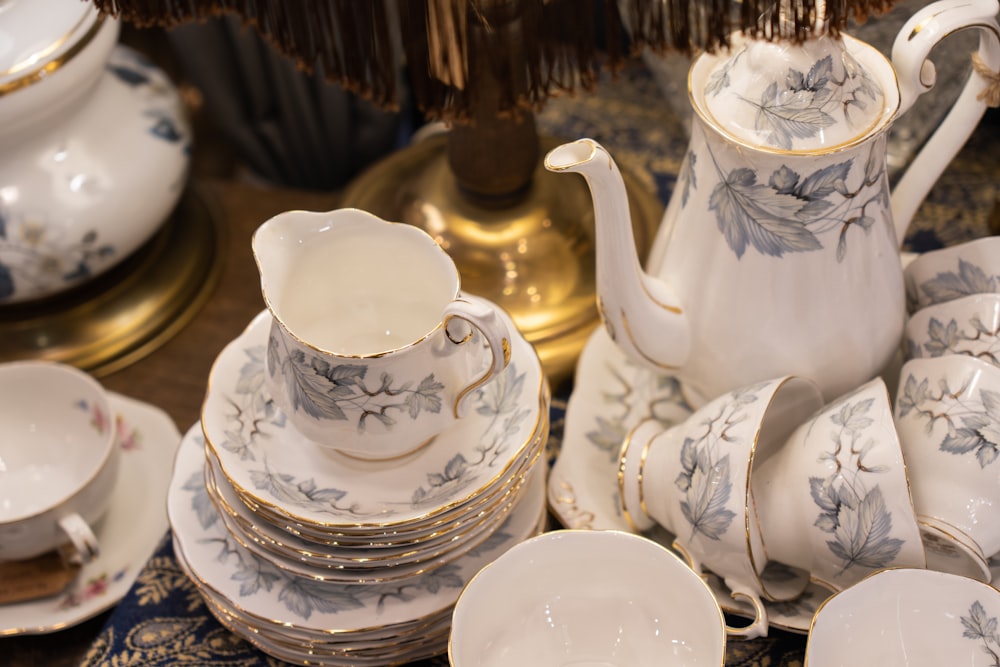 a table topped with lots of white and blue dishes