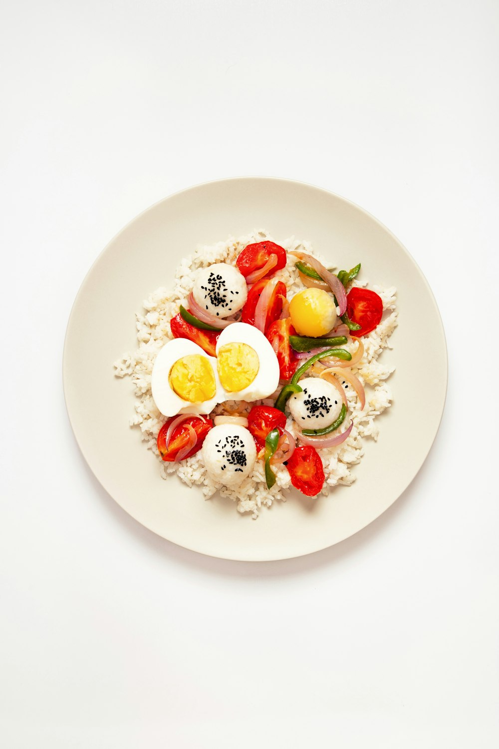 a white plate topped with eggs and vegetables