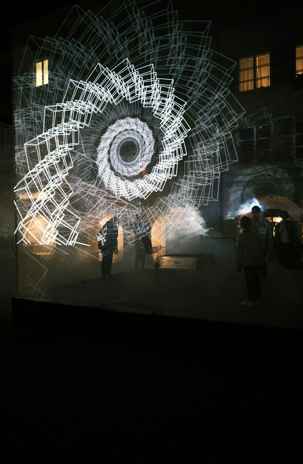 a group of people standing in front of a projected image