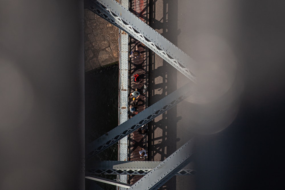 a group of people standing on top of a bridge