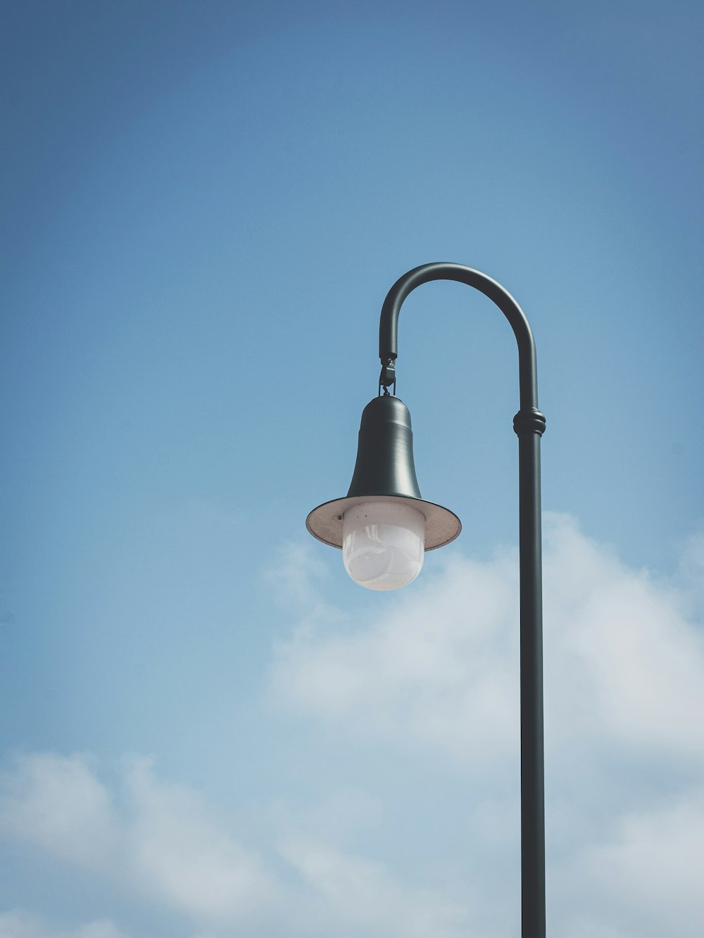 a street light with a clear blue sky in the background