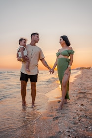 A joyful family walking hand-in-hand along a sunlit Sarasota beach at golden hour.