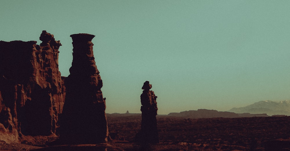 a large rock formation in the middle of a desert