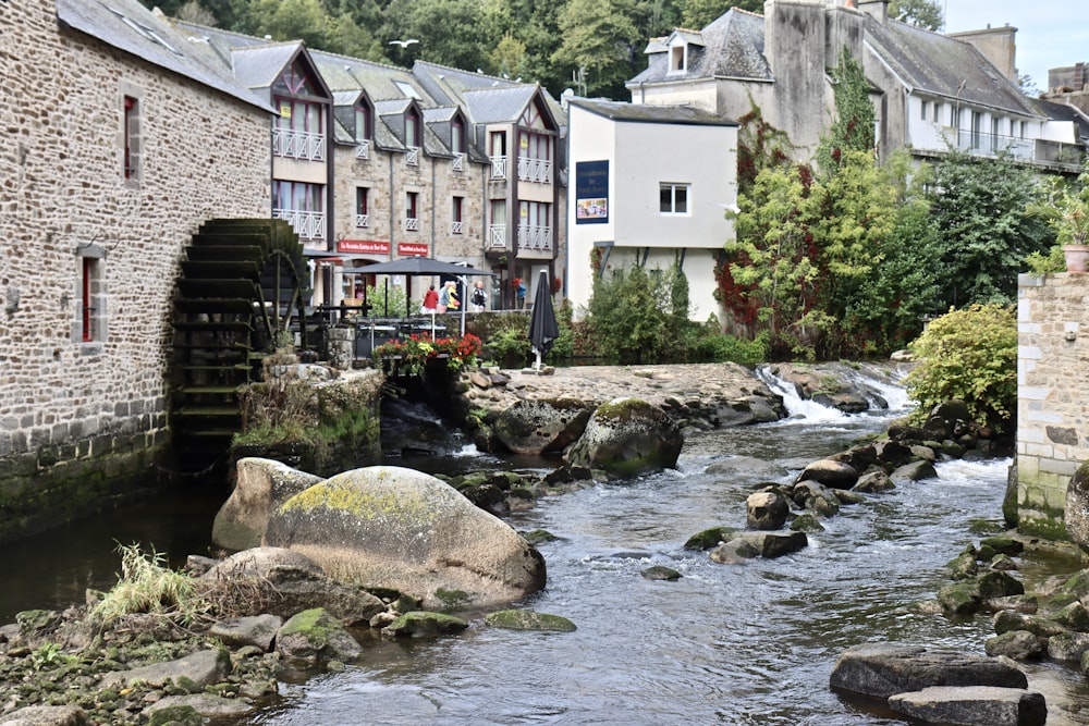 a river running through a small town next to tall buildings