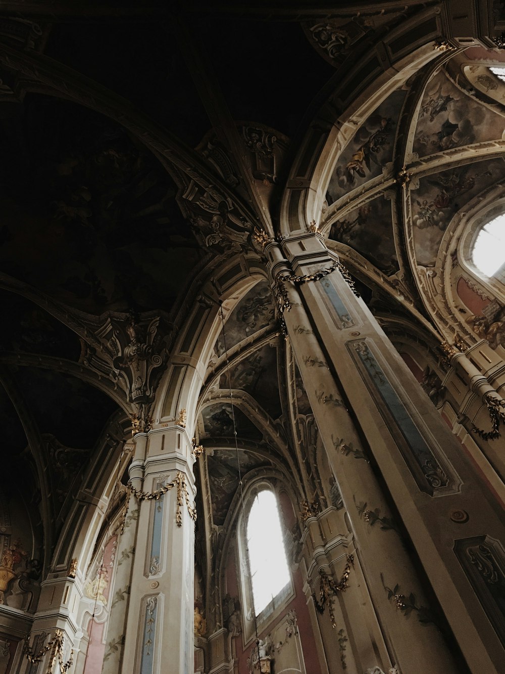 the ceiling of an old church with many windows