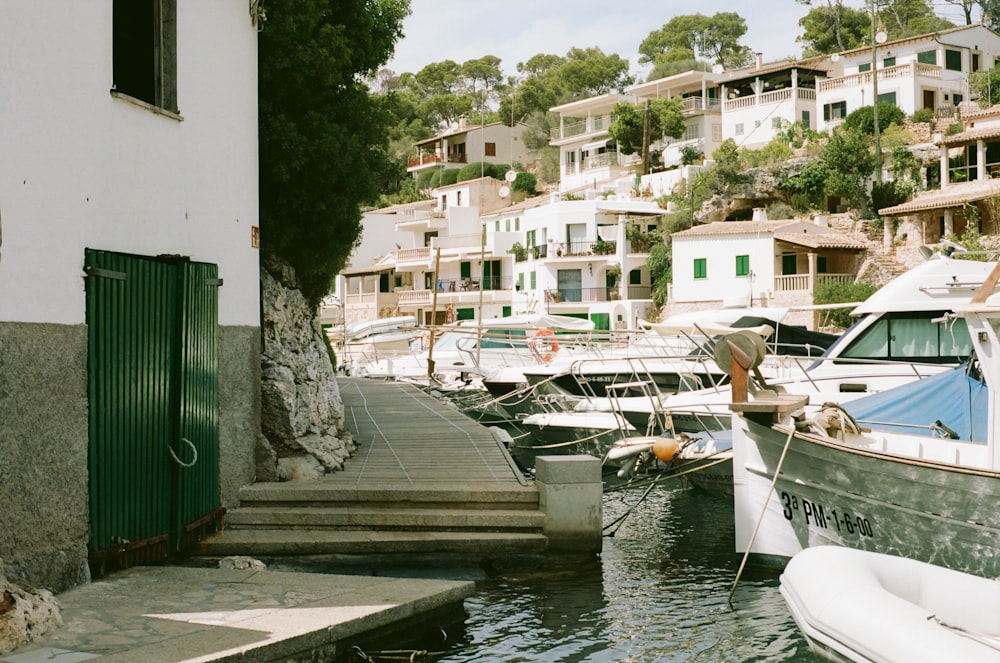 a row of boats sitting next to a dock