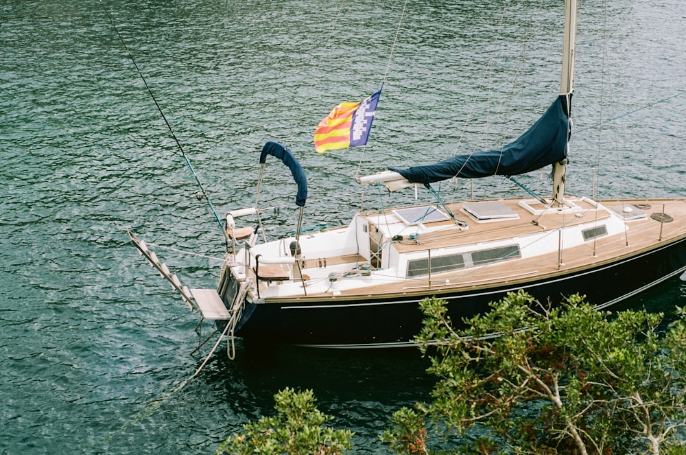 a small sailboat in a body of water