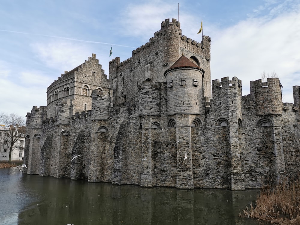 a castle with a lake in front of it