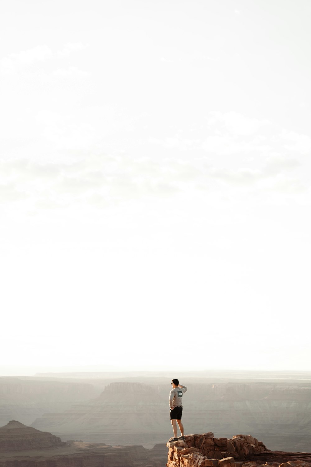 a man standing on top of a cliff