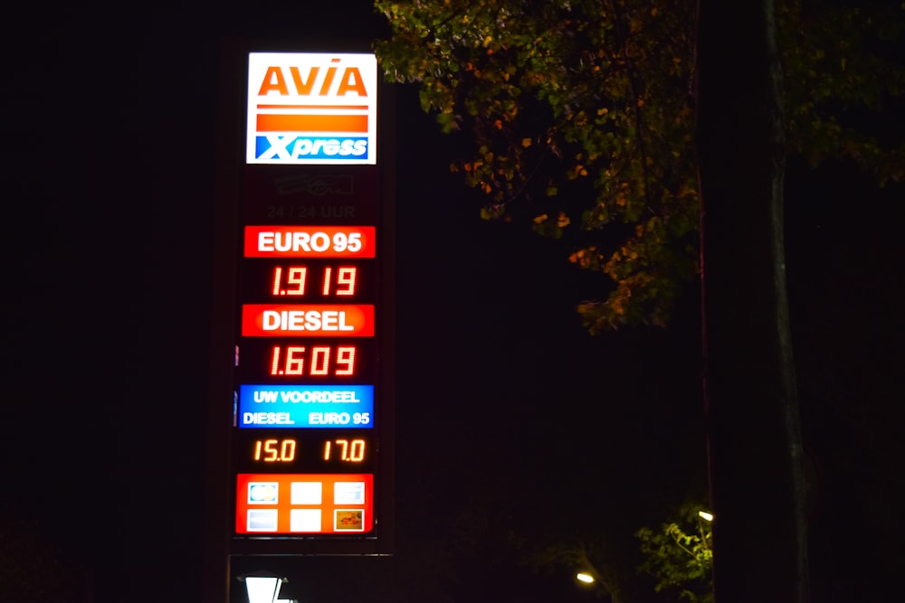 a gas station sign lit up at night