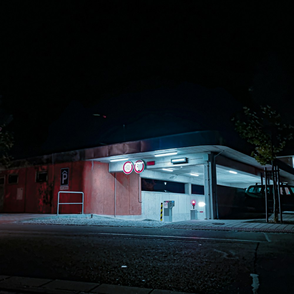 a gas station at night with a red light on