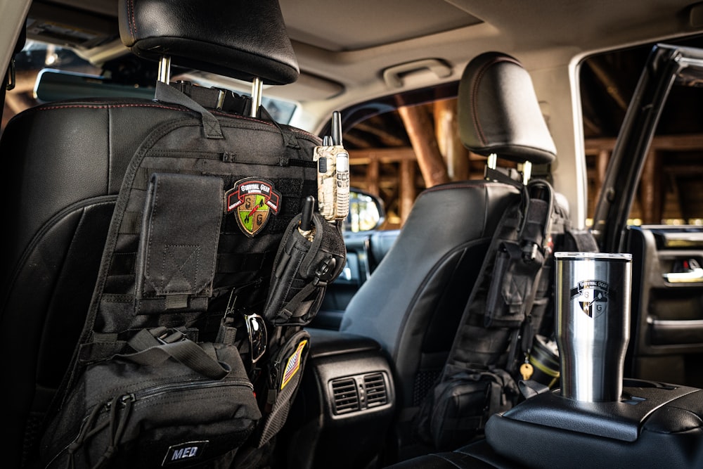 a back seat of a car with a backpack on it