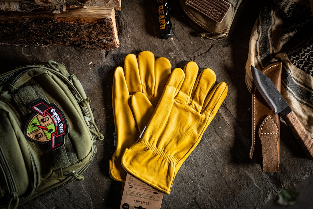 a pair of yellow gloves sitting on top of a table