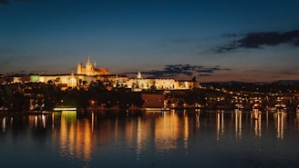 A stunning nighttime view of the Prague skyline from the penthouse terrace, with city lights sparkling below.