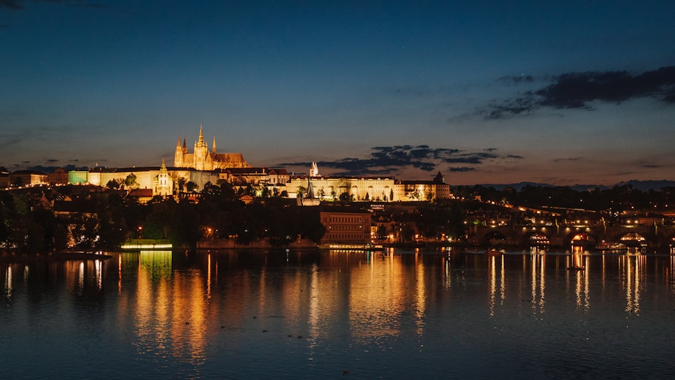 A stunning nighttime view of the Prague skyline from the penthouse terrace, with city lights sparkling below.