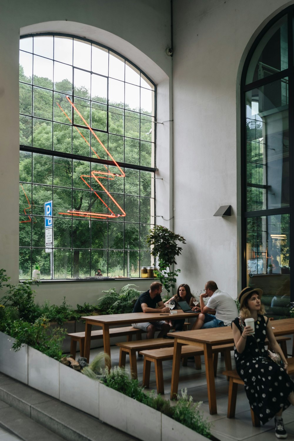 a group of people sitting at wooden tables